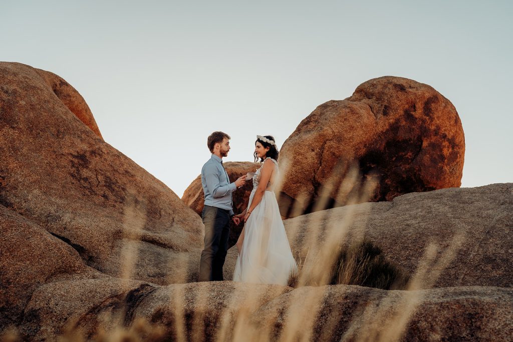 A couple reads vows to each other during a styled shoot.
