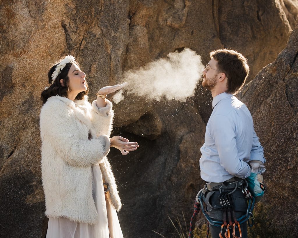 A couple acts silly together during a climbing styled shoot.